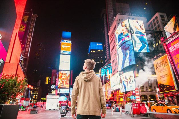 Boy Looking at billboards in New York