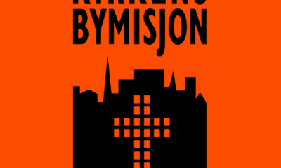Her vises logoen til Kirkens bymisjon. Et kristent kors over et bybilde